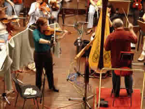 Photo of violinist Rebekah Binford, conductor Mátyás Antal, and members of the Győr Philharmonic Orchestra while recording Schiffman's Concerto for Violin. Jnos Richter Hall, Győr, Hungary (21 September 2007)