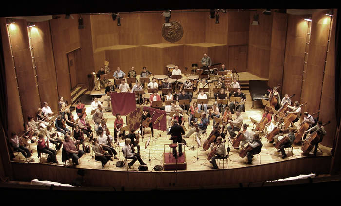 Photo of the Győr Philharmonic Orchestra (Mátyás Antal, conductor) recording Variations on "Branchwater" with guitarist Katalin Koltai. Győr, Hungary (12October2008)